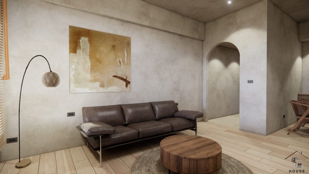 展現侘寂風客廳與玄關區域的室內設計圖；客廳的主角是一張深棕色皮革沙發，搭配圓形木質矮茶几，和下方圓形編織地毯，增添溫潤質感。牆面延續米灰色特殊塗料，中央掛著一幅大地色系抽象畫，右後方是採用拱門造型的開口，引導至玄關或內部空間，創造出柔和的視覺焦點，整體空間充滿自然和放鬆的氛圍