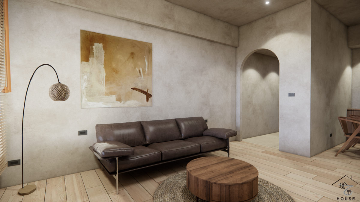 展現侘寂風客廳與玄關區域的室內設計圖；客廳的主角是一張深棕色皮革沙發，搭配圓形木質矮茶几，和下方圓形編織地毯，增添溫潤質感。牆面延續米灰色特殊塗料，中央掛著一幅大地色系抽象畫，右後方是採用拱門造型的開口，引導至玄關或內部空間，創造出柔和的視覺焦點，整體空間充滿自然和放鬆的氛圍