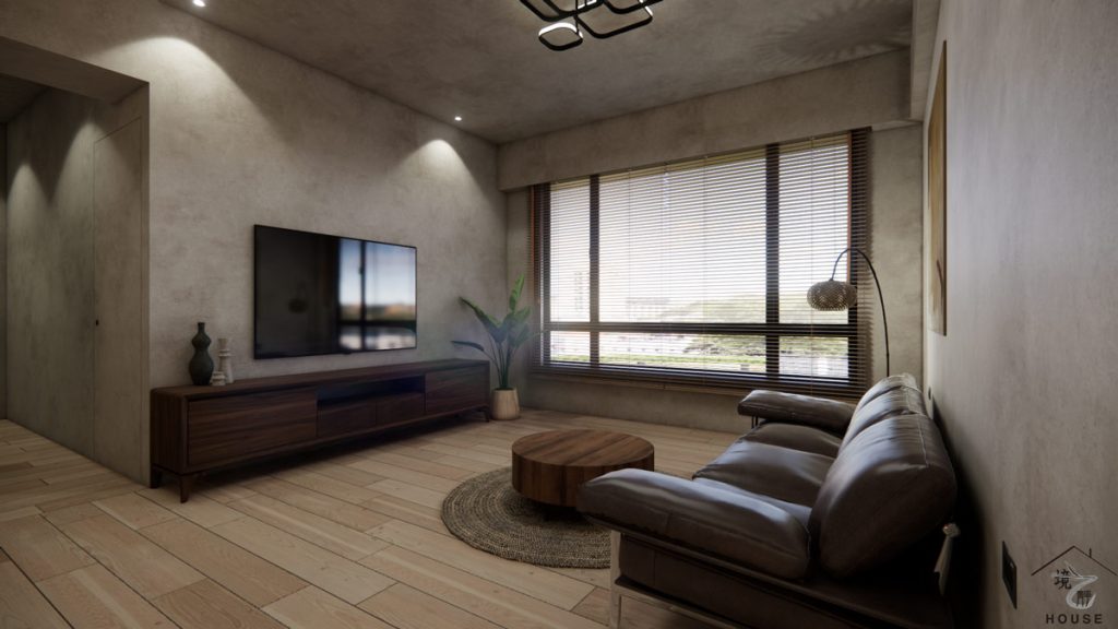 侘寂風客廳電視牆區域的特寫圖，牆面使用微水泥特殊塗料，營造出粗獷自然的質感，電視下方配置一座深胡桃木色的低矮電視櫃，線條極簡，提供了充足的收納空間；落地窗配有木百葉窗簾，將柔和的自然光引入室內，右側深棕色皮革沙發，搭配編織地毯和圓形木茶几，整體空間簡潔、大器，充滿禪意與寧靜。